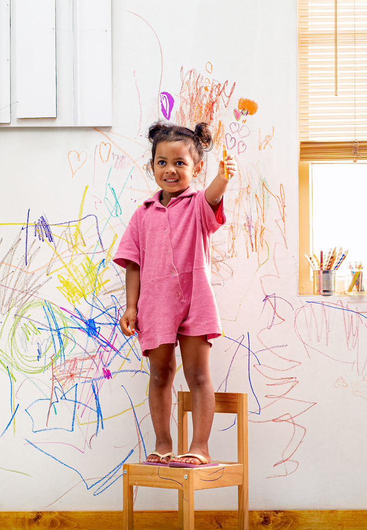 Child drawing on a wall